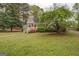 Charming home with a red door and a well-maintained lawn and landscaping at 6140 Ginn Se St, Covington, GA 30014