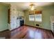Cozy kitchen with wooden floors, white cabinets, and vintage appliances at 6140 Ginn Se St, Covington, GA 30014