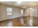 Spacious living room with wood floors, neutral walls, and natural light from windows at 6140 Ginn Se St, Covington, GA 30014