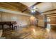 Living room with hardwood floors, wood-paneled walls, and an exposed beam ceiling at 6140 Ginn Se St, Covington, GA 30014