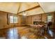 Living room with hardwood floors, fireplace, wood paneling, built-in shelves, and a piano at 6140 Ginn Se St, Covington, GA 30014