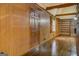 Living room featuring wood paneling, fireplace, and built-in shelves at 6140 Ginn Se St, Covington, GA 30014