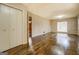 Spacious living room with hardwood floors, large window, and a closet, offering plenty of natural light at 6140 Ginn Se St, Covington, GA 30014