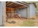 View of open shed with wood supports, a rototiller, and stacked bricks at 6140 Ginn Se St, Covington, GA 30014