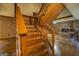A wooden staircase with a view of a brick fireplace and built-in shelves at 6140 Ginn Se St, Covington, GA 30014