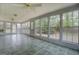 Bright sunroom with tile flooring and many large windows overlooking the backyard at 6140 Ginn Se St, Covington, GA 30014