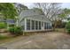 Rear view of the home featuring a sunroom addition and fenced-in yard at 6140 Ginn Se St, Covington, GA 30014