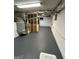 The unfinished basement has painted walls, exposed duct work, and painted concrete floor at 6121 N Main Se St, Acworth, GA 30101