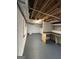 The unfinished basement is well-lit with painted walls, exposed duct work, and painted concrete floor at 6121 N Main Se St, Acworth, GA 30101