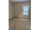 Neutral bedroom featuring a window with blinds and plush carpeting at 6121 N Main Se St, Acworth, GA 30101