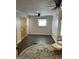 Spacious bedroom with dark floors, ceiling fan, and light-filled window at 6121 N Main Se St, Acworth, GA 30101