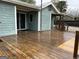 Exterior wooden deck featuring an open area, covered porch, and sliding glass doors at 6121 N Main Se St, Acworth, GA 30101