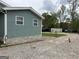 Exterior of home showcasing gravel driveway and yard space at 6121 N Main Se St, Acworth, GA 30101