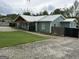 Inviting home with a metal roof, wood beam porch, and sprawling gravel driveway at 6121 N Main Se St, Acworth, GA 30101