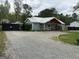 Exterior view of charming house with a metal roof, wood beam porch, and gravel driveway at 6121 N Main Se St, Acworth, GA 30101