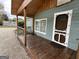 Attractive front porch with dark wood flooring and a dark wood door, creating curb appeal at 6121 N Main Se St, Acworth, GA 30101