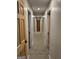 Long hallway with multiple wooden doors and neutral carpet at 6121 N Main Se St, Acworth, GA 30101