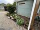 Landscaping featuring lush greenery and plantings, complemented by durable vinyl siding at 6121 N Main Se St, Acworth, GA 30101