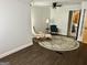 Living room area with hardwood floors, chairs, and large round area rug at 6121 N Main Se St, Acworth, GA 30101