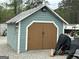 The outbuilding features batten siding, brown double doors, and a gable roof at 6121 N Main Se St, Acworth, GA 30101