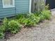 Picture of the side yard, showcasing gravel and established garden beds at 6121 N Main Se St, Acworth, GA 30101