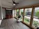 Bright sunroom features hardwood floors and large windows, perfect for relaxing and enjoying the natural light at 6121 N Main Se St, Acworth, GA 30101