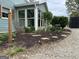 Exterior garden with river rock, mulch, stone pavers and green plants at 6121 N Main Se St, Acworth, GA 30101