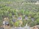 Aerial view of the property outlining a large wooded lot with mature trees, landscaped grounds, and a private pool at 70 Barrington Farms Ct, Sharpsburg, GA 30277
