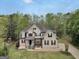 Eye-catching home featuring a manicured lawn and neutral stucco facade with contrasting black shutters at 70 Barrington Farms Ct, Sharpsburg, GA 30277