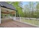 Large wooden deck with white railings overlooking a wooded backyard at 70 Barrington Farms Ct, Sharpsburg, GA 30277