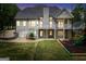 Rear exterior view of a beautiful home featuring a spacious yard and deck at 70 Barrington Farms Ct, Sharpsburg, GA 30277