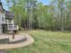 Spacious backyard featuring lush greenery, mature trees, and an inviting playset for children at 70 Barrington Farms Ct, Sharpsburg, GA 30277