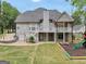 Expansive backyard view showcasing a multi-level deck and a play area at 70 Barrington Farms Ct, Sharpsburg, GA 30277