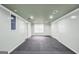 Clean and bright basement with neutral walls, tiled floors, and ample natural light at 70 Barrington Farms Ct, Sharpsburg, GA 30277