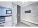 Modern bathroom with shower and marble-like tile with a sleek, dark vanity at 70 Barrington Farms Ct, Sharpsburg, GA 30277