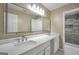Bathroom featuring dual sinks, a wide mirror and a glass-enclosed shower at 70 Barrington Farms Ct, Sharpsburg, GA 30277