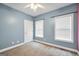 Clean bedroom featuring neutral walls, two windows providing natural light, and carpet floors at 70 Barrington Farms Ct, Sharpsburg, GA 30277