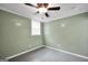 Bedroom boasts ceiling fan, neutral paint, and epoxy floors at 70 Barrington Farms Ct, Sharpsburg, GA 30277