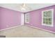 Bright bedroom with windows, carpet and a ceiling fan at 70 Barrington Farms Ct, Sharpsburg, GA 30277