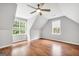 Spacious bedroom with two large windows, vaulted ceilings, and wood-look flooring at 70 Barrington Farms Ct, Sharpsburg, GA 30277