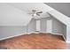 Spacious bonus room with hardwood floors and a ceiling fan offers flexible living space at 70 Barrington Farms Ct, Sharpsburg, GA 30277