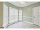 Corner room with a tiled floor, large windows, and neutral paint at 70 Barrington Farms Ct, Sharpsburg, GA 30277