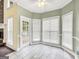 Bright breakfast nook with lots of windows and a door leading to the deck at 70 Barrington Farms Ct, Sharpsburg, GA 30277