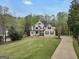 Desirable home with a pristine lawn, mature trees, and extended driveway provides ample space and privacy at 70 Barrington Farms Ct, Sharpsburg, GA 30277