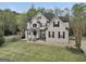Beautiful two-story home with a manicured lawn, black shutters, and a charming front entrance at 70 Barrington Farms Ct, Sharpsburg, GA 30277
