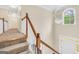 Light-filled foyer area with staircase and chandelier, offering an inviting entrance at 70 Barrington Farms Ct, Sharpsburg, GA 30277