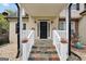 Inviting front porch with stone tile and white railings welcomes you to this beautifully designed home at 70 Barrington Farms Ct, Sharpsburg, GA 30277