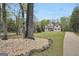 Charming two-story home with a lush front lawn, mature trees, and a long driveway at 70 Barrington Farms Ct, Sharpsburg, GA 30277