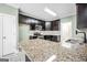 Well-appointed kitchen with granite counters, stainless steel appliances, and neutral color palette at 70 Barrington Farms Ct, Sharpsburg, GA 30277