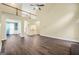 Spacious living room with hardwood floors, staircase, and views to the dining room and entrance at 70 Barrington Farms Ct, Sharpsburg, GA 30277